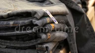 德国纽伦堡-2018年12月3日：一个巨大的柜台，货<strong>架</strong>上躺着一排<strong>折叠</strong>的时髦牛仔裤。 牛仔裤